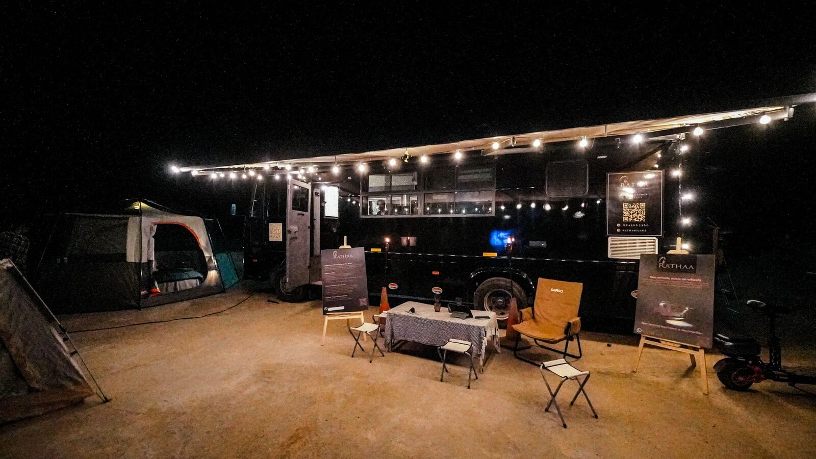 Ratha Black Caravan overnight trip — festive lights at a caravan campsite