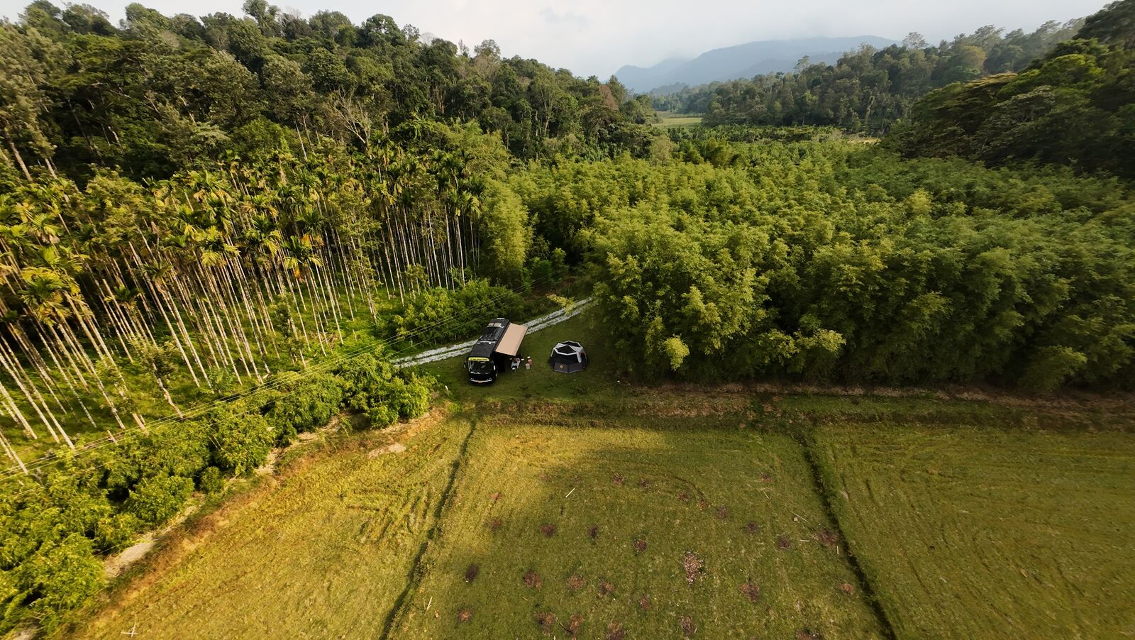 Ratha luxury caravan for rent in Bangalore — aerial view amid bamboo forest