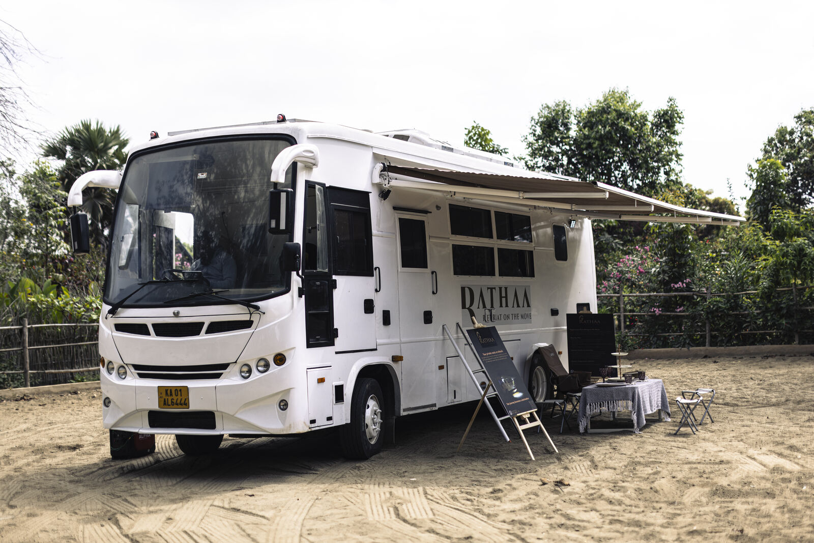 Ratha White Caravan hire Bangalore — parked at scenic outdoor location